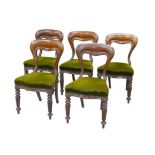 Five Victorian mahogany balloon back dining chairs, with green upholstered seats, turned fore legs