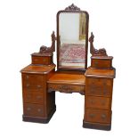 A Victorian mahogany dressing table, with hinged rectangular mirror, raised upon twin pedestals, a/