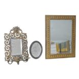 A Brass framed girandole mirror, with a pierced decorated frame and two candle holders, 28 by 42cm