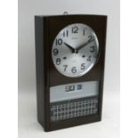 A Seiko wall clock, with 19cm silvered dial and calendar day-date display below, single door,