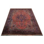 A hand knotted Persian carpet, with pink ground and filled arabesque floral field, floral eight band