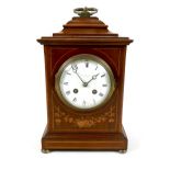 An Edwardian mahogany and inlaid mantel clock, white enamel dial, 10cm, signed Pearce & Sons, Leeds,