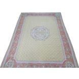 An Aubusson rug, with central floral motif and floral sprays and vines to its border, 359 by 261cm.