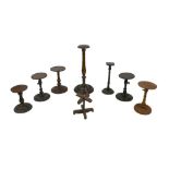 A collection of wooden wig stands and candlestick holders, including a 19th century mahogany wig