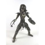 A handmade scratch metal sculpture of 'The Predator', made entirely of motorcycle parts, 65cm high.