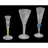 Three 20th century continental decorative wine glasses, all indistinctly signed, comprising an air