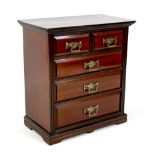A miniature Edwardian chest of drawers, brass handles, 32 by 18 by 34.5cm high.