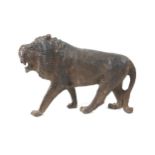 A 19th century carved wooden sculpture of a lion, 24 by 7.5 by 16.5cm high.