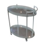 A 20th century chrome cocktail trolley, with oval mirrored top and base surfaces, raised upon