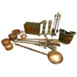 A collection of copper and brass, including a set of copper saucepans, a pair of fire dogs in the