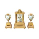 A late 19th century French gilt metal clock garniture, with gilt plinths, the clock with painted