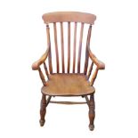 A Victorian oak and beech high back Windsor open armchair, with turned legs joined by an H