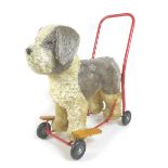 A mid-20th century Lines Brothers push-along baby walker, in the form of a dog, light brown mohair