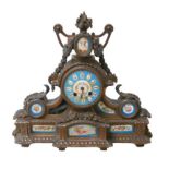 A 19th century mantel clock, with Roman numeral dial, brass mounts and enamel panels, 37 by 11 by