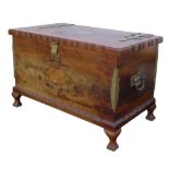 A mid 20th century wooden chest, with brass hinges, and carry handles to sides, raised on short