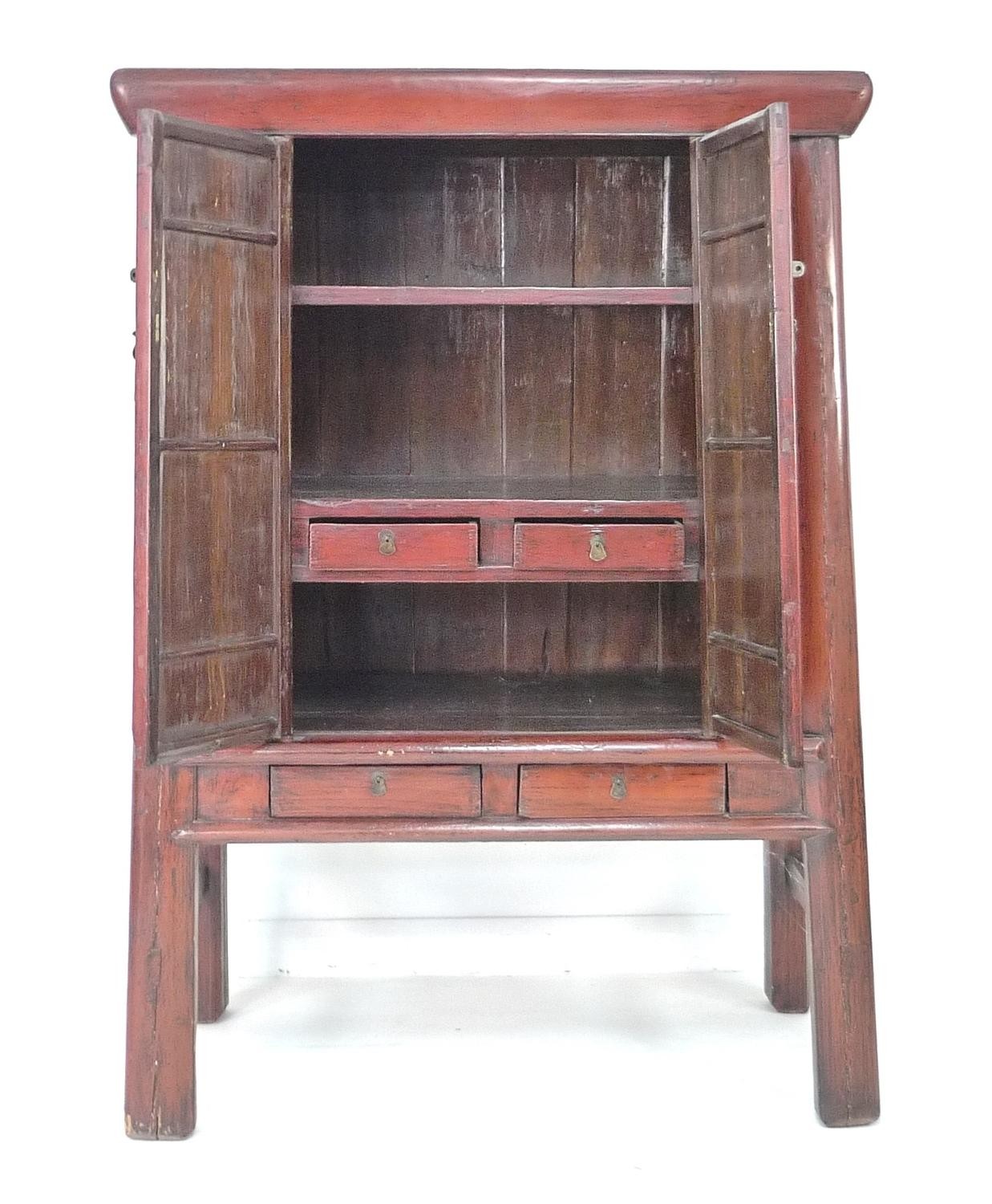 A modern Chinese style cabinet, of tapering form with red lacquered finish, brass butterfly shaped - Image 2 of 4