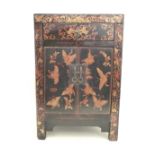 A Chinese style black lacquered side cabinet, with butterfly decoration, one drawer over a twin door