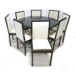 A vintage Pierre Vandel hexagonal dining table and eight matching chairs, with black and silvered