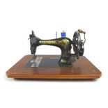 A Singer sewing machine, serial 14691646, in wooden case, together with a Victorian wheel barometer,