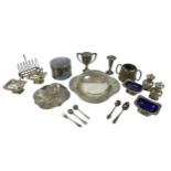 A group of silver plated wares, including cruet sets with blue glass liners, a twin handled pot