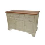 A shabby chic sideboard, with a small and large cupboard under six small drawers, with pine top,