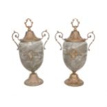 A pair of marble effect urns, with gilt metal decoration, twin handles, and raised on a circular
