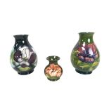 Three Moorcroft vases, comprising two William Moorcroft ovoid vases, decorated in Purple Magnolia