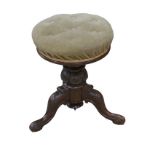 A Victorian oak piano stool, with upholstered circular seat, carved tripod base with cabriole legs