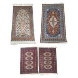 A group of four rugs, including a pair, and a silk rug