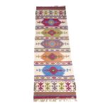 A Kilim runner, with Aztec style design, 243 by 82cm.