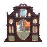A Victorian mahogany overmantle mirror with central shield shaped bevelled glass, galleried above