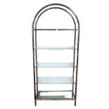A modern tubular metal and glass shelving / display unit, with five shelves and arched frame.