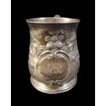 A George II silver tankard, with repousse floral decoration, rubbed hallmarks possibly London