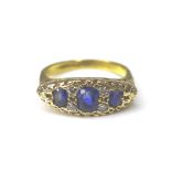 A three stone blue sapphire and diamond ring, the central sapphire 3 by 5mm, four small round cut