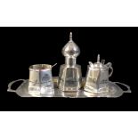 An Egyptian white metal cruet, decorated with a signed design of a river Nile scene with boats,