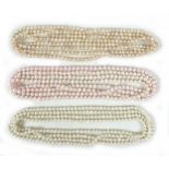 A group of three 'flapper' pearl necklaces, all with no clasps, misshapen but mainly round pearls,