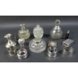 A group of four silver topped cut glass dressing table bottles, largest 14cm high, a silver matchbox