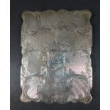An early Victorian silver card case, with scallop shaped outline, engraved C scroll, floral and