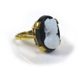 An 18ct gold mourning cameo ring, the cameo of a lady in profile, mounted on black, 10 by 13mm,