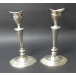 A matched pair of George V silver candlesticks, with removable inserts and weighted bases, D & M