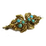 An Art Nouveau yellow metal brooch, set with six turquoise cabochon, each 3.0mm, in mirrored