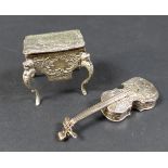 A late 19th century Hanau silver novelty box, in the form of a violin, with embossed decoration of