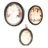 A group of three cameo brooches, comprising a 19th century example carved with three classical