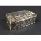 A Victorian silver box, the hinged cover embossed with a village scene depicting five standing