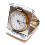 An Art Deco silver travel clock, with sprung fold out case, Swiss watch movement numbered 73637,