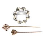 Two pearl mounted stick pins, comprising a 9ct gold ruby and pearl stick pin, 0.8g, a yellow metal