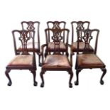 A set of six Chippendale style dining chairs, with shaped top rails, pierced carved backs,