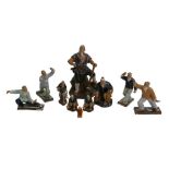 A group of Chinese 'mud man' figurines, in various poses, largest 25cm high, together with a Wade