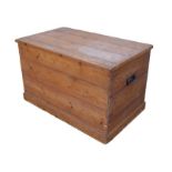 A 20th century pine storage chest, with lift lid and metal carry handles, 80 by 49 by 49.5cm high.