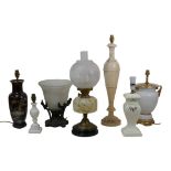 A group of table lamps, including an Edwardian oil lamp, 55cm high, an early 20th century cast